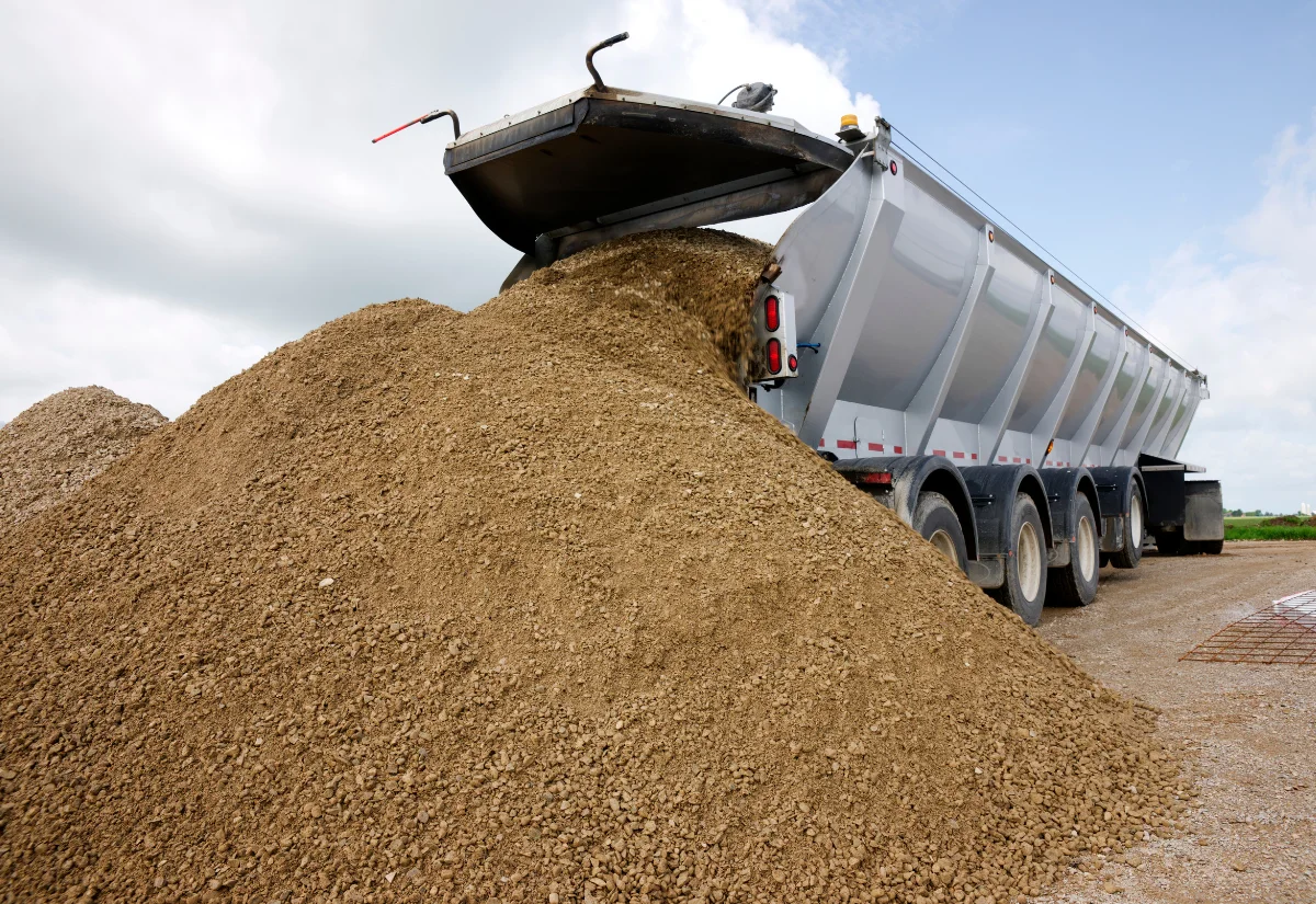 Gravel truck delivering aggregate